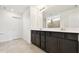 Bathroom with dual vanities, modern cabinetry, and neutral tile at 10537 Hidden Banks Gln, Parrish, FL 34219