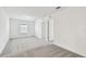 Bright bedroom with neutral walls, plush gray carpet, and natural light from a window at 10537 Hidden Banks Gln, Parrish, FL 34219