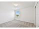 Bright bedroom featuring neutral walls, a window with blinds, and plush gray carpet at 10537 Hidden Banks Gln, Parrish, FL 34219