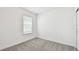 Empty bedroom with neutral carpet, a window with blinds, and fresh paint at 10537 Hidden Banks Gln, Parrish, FL 34219