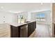 Bright, open-concept kitchen with island sink and stainless steel dishwasher at 10537 Hidden Banks Gln, Parrish, FL 34219