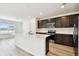 Modern kitchen featuring stainless steel appliances, a large island, and ample cabinet space at 10537 Hidden Banks Gln, Parrish, FL 34219