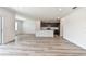 Large open concept living and kitchen area with light gray modern floors at 10537 Hidden Banks Gln, Parrish, FL 34219
