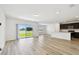 Bright, open-concept living area with lake views and modern kitchen in background at 10537 Hidden Banks Gln, Parrish, FL 34219