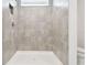 Modern tiled shower featuring neutral tones and a sleek design in the bathroom at 10537 Hidden Banks Gln, Parrish, FL 34219