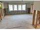 Spacious living room under renovation with large windows at 113 Michigan Blvd, Dunedin, FL 34698