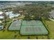 Aerial view of community amenities including a swimming pool, tennis courts, and basketball court, surrounded by lush greenery at 13123 Rain Lily Dr, Riverview, FL 33579