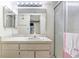 Bathroom features a well-lit vanity and a glass-enclosed shower for a clean and functional design at 1420 Oak Hill Dr # 102, Dunedin, FL 34698