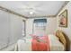 Bright bedroom with a view to the outside, featuring a ceiling fan and comfortable bed at 1420 Oak Hill Dr # 102, Dunedin, FL 34698