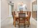 Elegant dining room with a chandelier, decorative mirrors, and a view into the kitchen at 1420 Oak Hill Dr # 102, Dunedin, FL 34698