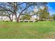 Well-maintained community grounds with mature trees, lush green lawns, and manicured landscaping at 1420 Oak Hill Dr # 102, Dunedin, FL 34698