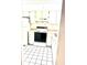 This kitchen features all-white appliances, classic cabinetry, and bright lighting for a clean aesthetic at 1420 Oak Hill Dr # 102, Dunedin, FL 34698