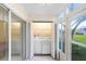 Bright laundry room with washer and dryer on an enclosed patio at 1420 Oak Hill Dr # 102, Dunedin, FL 34698