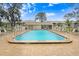 Community pool featuring lounge chairs around the pool deck and clear blue skies at 1420 Oak Hill Dr # 102, Dunedin, FL 34698