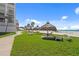 Green lawn featuring tiki huts and lounge seating just steps from the sandy beach at 1430 Gulf Blvd # 603, Clearwater Beach, FL 33767