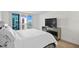 Relaxing Primary bedroom with a view, TV, and luxurious mirrored dresser at 1430 Gulf Blvd # 603, Clearwater Beach, FL 33767