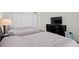Well-lit bedroom featuring two beds, closet, and a dresser with a TV at 1430 Gulf Blvd # 603, Clearwater Beach, FL 33767