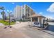Beachfront condo gatehouse entrance with street view and lush tropical foliage at 1430 Gulf Blvd # 603, Clearwater Beach, FL 33767