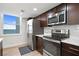 Modern kitchen with stainless steel appliances, dark wood cabinets, and scenic water view at 1430 Gulf Blvd # 603, Clearwater Beach, FL 33767