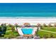 Stunning oceanfront pool with tiki huts and lush landscaping offers a resort-style living experience at 1430 Gulf Blvd # 603, Clearwater Beach, FL 33767