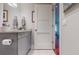 Stylish bathroom vanity featuring granite countertops and modern fixtures with an adjacent door at 146 4Th Ne Ave # 204, St Petersburg, FL 33701