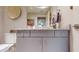 Bathroom featuring gray vanity, granite countertop, decorative mirror, and neutral wall color at 146 4Th Ne Ave # 204, St Petersburg, FL 33701