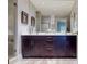 Modern bathroom featuring a large mirror, stylish vanity with dual sinks, and sleek lighting fixtures at 146 4Th Ne Ave # 204, St Petersburg, FL 33701