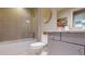 Well-lit bathroom showcasing a shower-tub combo, gray vanity, and decorative wall accents at 146 4Th Ne Ave # 204, St Petersburg, FL 33701