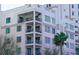 Upscale condominium building with balconies, dark trim windows, and manicured trees at 146 4Th Ne Ave # 204, St Petersburg, FL 33701