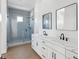 This bathroom offers double sinks, white cabinets, quartz countertops and a walk-in shower at 1753 25Th N Ave, St Petersburg, FL 33713