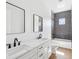 Modern bathroom featuring a double vanity, sleek fixtures, subway tile in shower, and wood-look flooring at 1753 25Th N Ave, St Petersburg, FL 33713