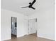 This bright bedroom showcases wood-look flooring, white walls, a ceiling fan and two doorways at 1753 25Th N Ave, St Petersburg, FL 33713
