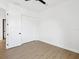This bedroom features wood-look flooring, white walls, a closet and a doorway at 1753 25Th N Ave, St Petersburg, FL 33713