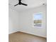This bedroom features wood-look flooring, white walls, a window and a modern ceiling fan at 1753 25Th N Ave, St Petersburg, FL 33713