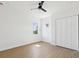This bedroom features wood-look flooring, white walls, a closet and two windows at 1753 25Th N Ave, St Petersburg, FL 33713