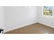 Bright bedroom featuring wood floors, neutral paint, natural light, and a large window at 1753 25Th N Ave, St Petersburg, FL 33713