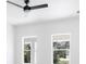 Bedroom with a dark ceiling fan and two windows overlooking the backyard at 1753 25Th N Ave, St Petersburg, FL 33713