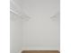This walk-in closet offers white shelving and wood-look flooring at 1753 25Th N Ave, St Petersburg, FL 33713