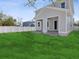 Backyard view of a two-story home with gray siding, a covered porch, and a fenced-in yard at 1753 25Th N Ave, St Petersburg, FL 33713