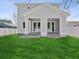 Rear exterior view of a two-story home with a gray exterior and a fenced-in backyard at 1753 25Th N Ave, St Petersburg, FL 33713