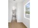 Hallway with white walls, wood floors, and a window that lets in lots of natural light at 1753 25Th N Ave, St Petersburg, FL 33713