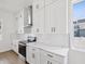 Well-lit kitchen with white cabinets, modern appliances, and luxurious stone countertops at 1753 25Th N Ave, St Petersburg, FL 33713