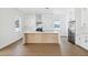 Contemporary kitchen with marble countertop island, stainless refrigerator, and wood grain floors at 1753 25Th N Ave, St Petersburg, FL 33713