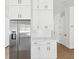 Close up of the bright kitchen with stainless steel refrigerator and white cabinets at 1753 25Th N Ave, St Petersburg, FL 33713