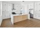 Modern kitchen featuring white cabinets, a center island with stone countertops, and stainless steel appliances at 1753 25Th N Ave, St Petersburg, FL 33713