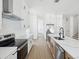 Bright, modern kitchen featuring stainless steel appliances and a spacious island with marble countertops at 1753 25Th N Ave, St Petersburg, FL 33713