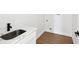 Laundry room featuring wood floors, neutral paint, and a stainless-steel sink at 1753 25Th N Ave, St Petersburg, FL 33713