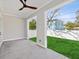 View from the porch towards the lawn; porch has a ceiling fan at 1753 25Th N Ave, St Petersburg, FL 33713