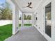 Open porch with a ceiling fan, concrete floor, wood siding, and multiple door entries at 1753 25Th N Ave, St Petersburg, FL 33713