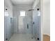 This glass enclosed walk-in shower features a rain shower head, gray tiling and a small window at 1753 25Th N Ave, St Petersburg, FL 33713